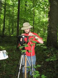 Nathan levels the camera for the mispherical photographs of the forest canopy.