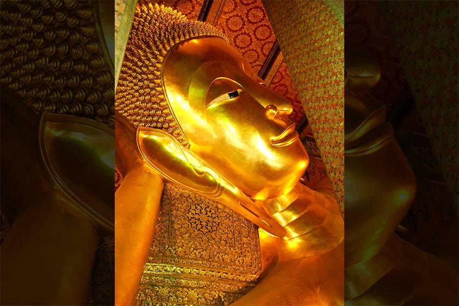 A detail of the <em>Reclining Buddha</em> statue at Wat Pho, a Buddhist temple complex in Bangkok, Thailand.