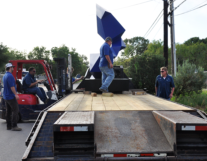 Loading the sculptures on a flatbed truck to be moved to UTSA’s campuses