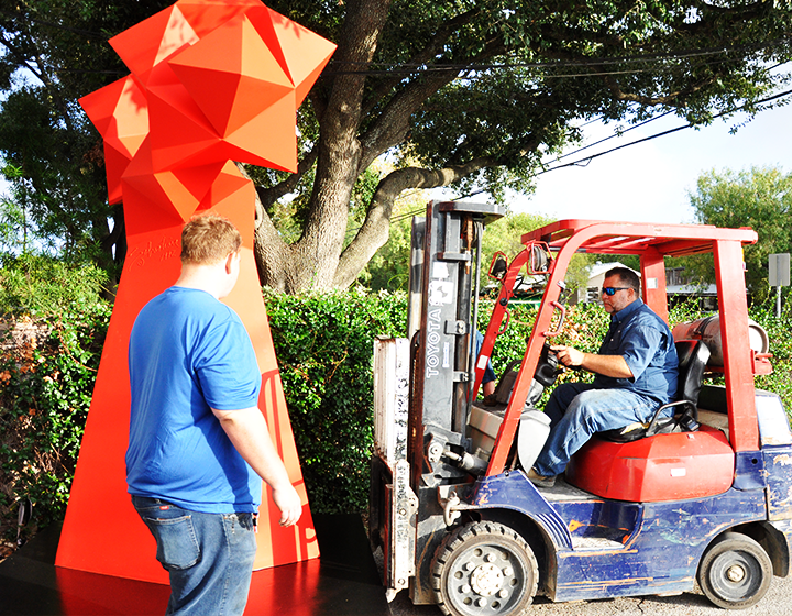 Loading the sculptures on a flatbed truck to be moved to UTSA’s campuses