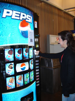 student at soda machine