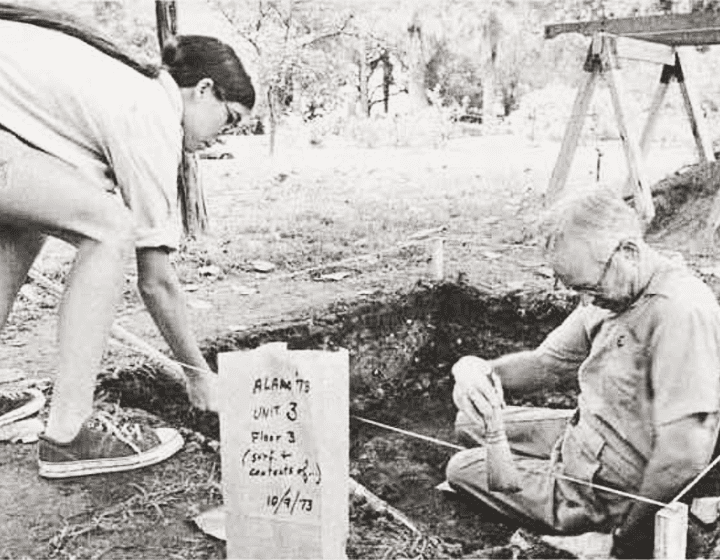 Students Molly Madden and Feris Bass scrutinize and remove layers of soil and deposits.