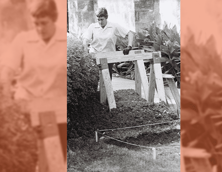 Student Ann Fox sets up barriers to protect excavation pits.