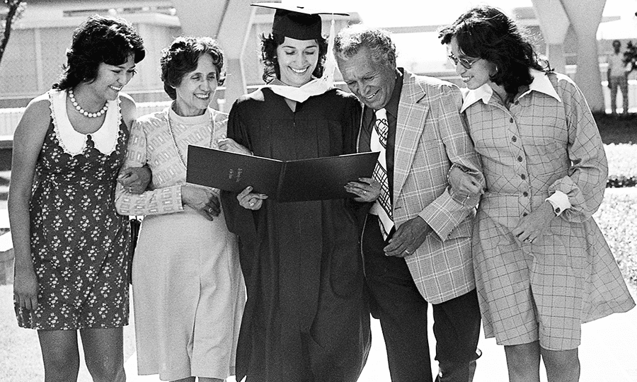 New graduate Dolores Cardona beams at her new diploma with her family members, sister Gloria Jimenez, mom Dolores Cardona, dad Bert Cardona, and sister Hope Cardona.