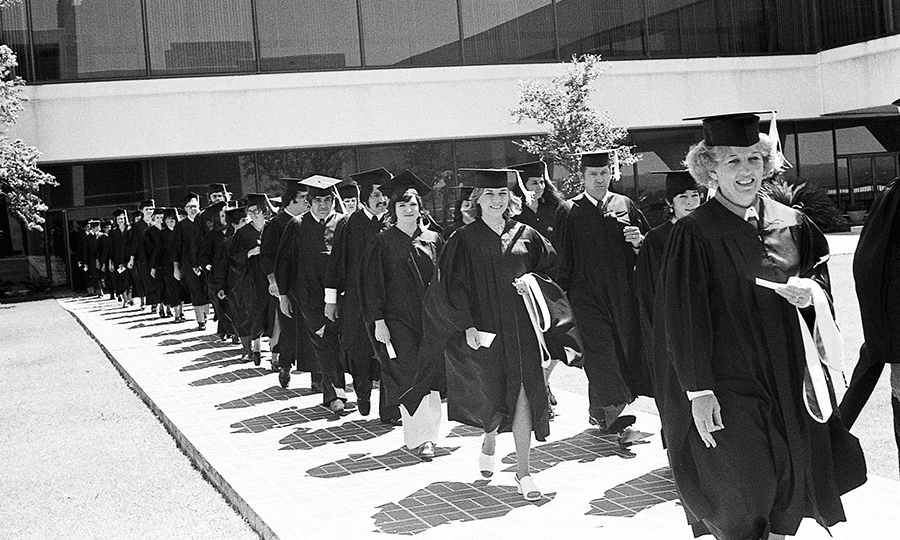 Graduating students leave their staging area to head to the auditorium, where UTSA’s first commencement ceremonies were held on August 18, 1974.