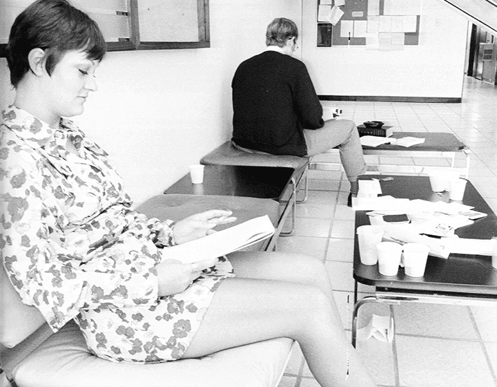 A pair of students catch some solitary study time in the lobby of UTSA’s Koger Center campus.