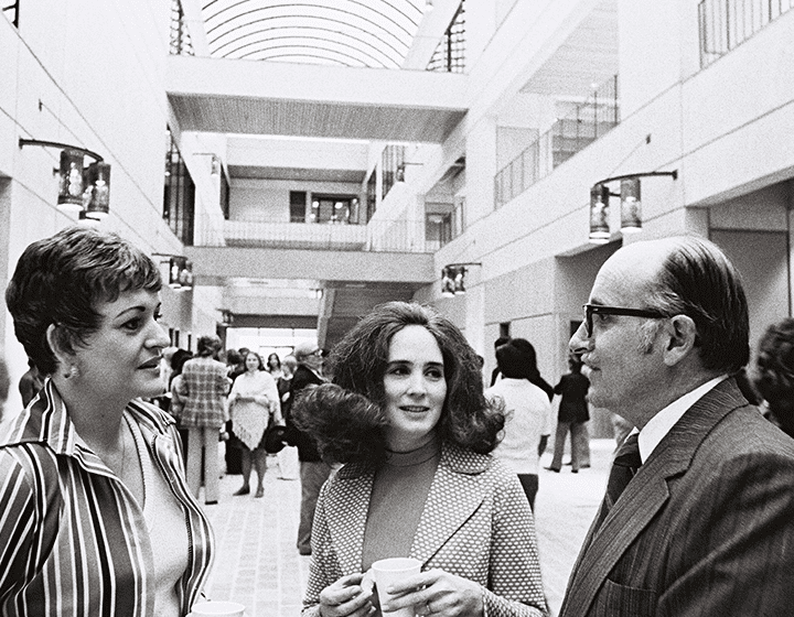 President Peter Flawn discusses campus plans with visitors at the opening of the new Humanities-Business Building.