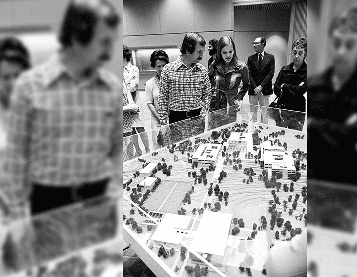 Visitors of the new building look at a scale model of the vision for the campus’ design.