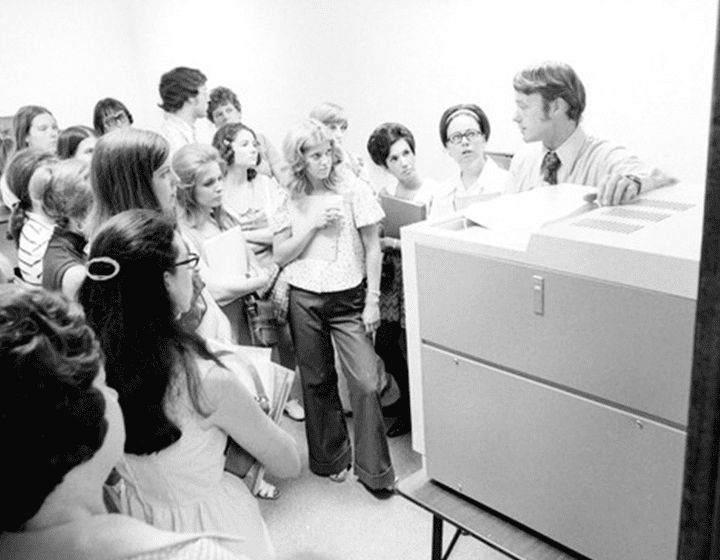 Director of Libraries Michael Kelley instructs UTSA’s first students, attending classes at the Koger Center, how to find needed books on lists on microfilm that would be borrowed from UT Austin’s library.