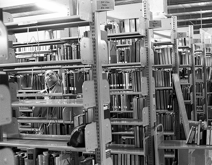 Getting the book volumes onto the temporary shelves in the gym.