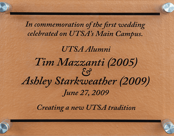A plaque outside the H-E-B Student Union ballroom heralds UTSA’s first wedding reception.