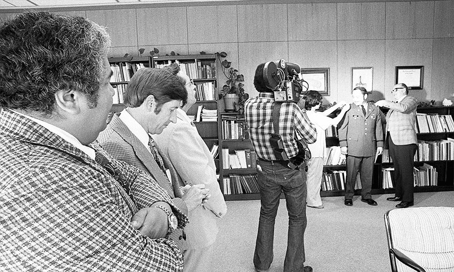 San Antonio media document the ceremony, held in Flawn’s office.