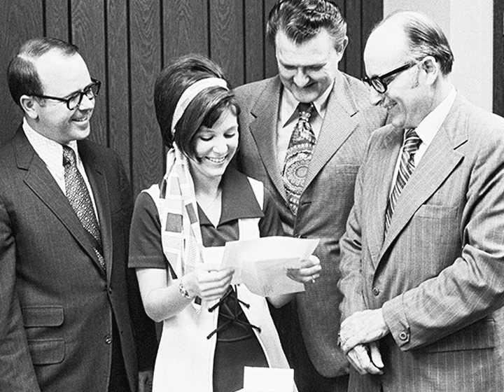 Tholen receives her acceptance letter March 30, 1973, from UTSA registrar Richard Lewis, UT System regent James Bauerle, and President Peter Flawn.