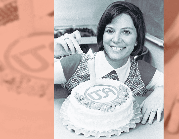 Tholen lights a candle for a marketing campaign to celebrate UTSA’s first birthday.