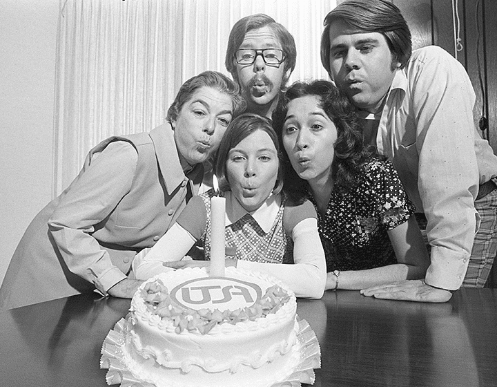 Tholen and other UTSA students pose with a cake for a marketing campaign to celebrate UTSA’s first birthday.