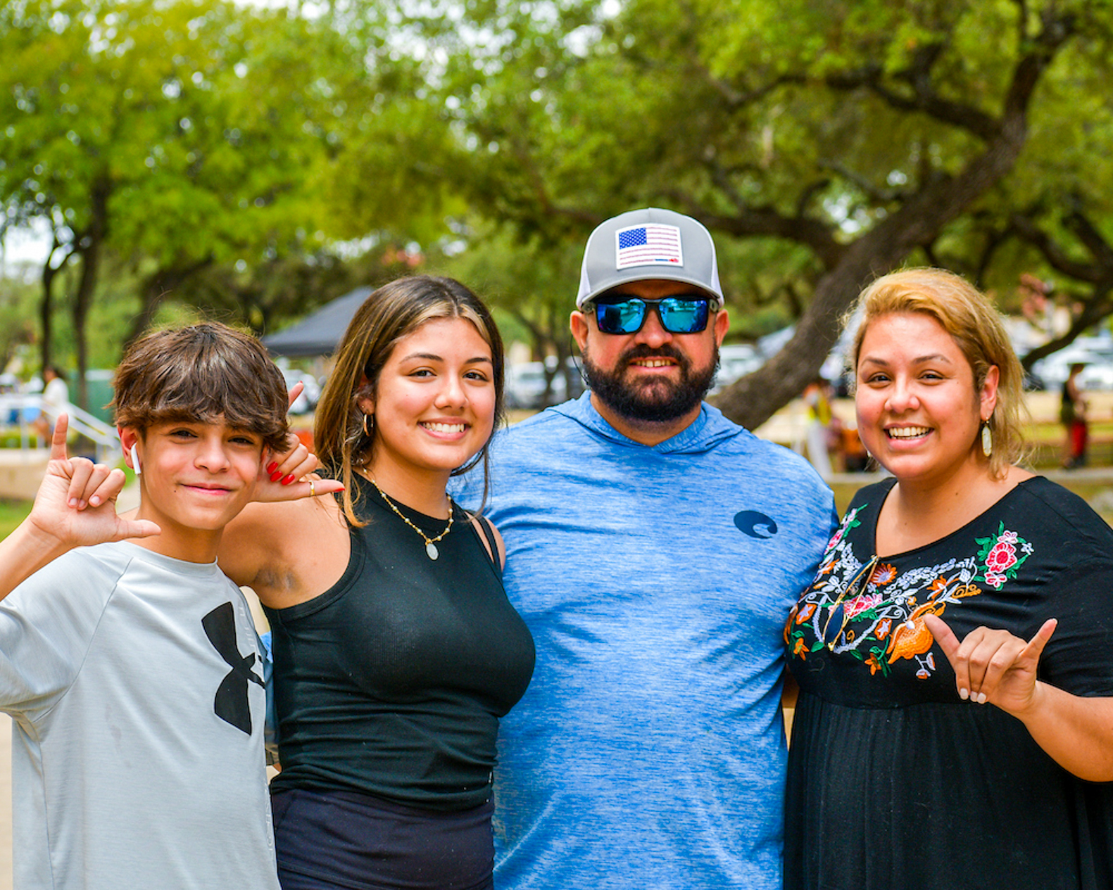Four UTSA family members gather close and smile