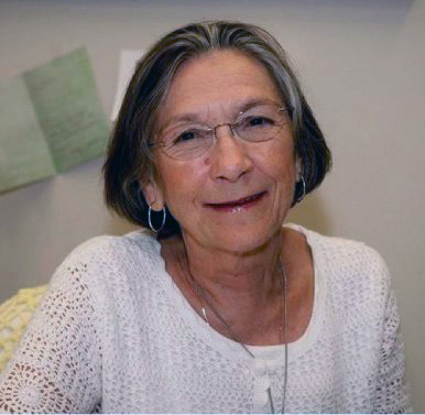 Headshot of Judith G. Gardner smiling, wearing a white crochet blouse.
