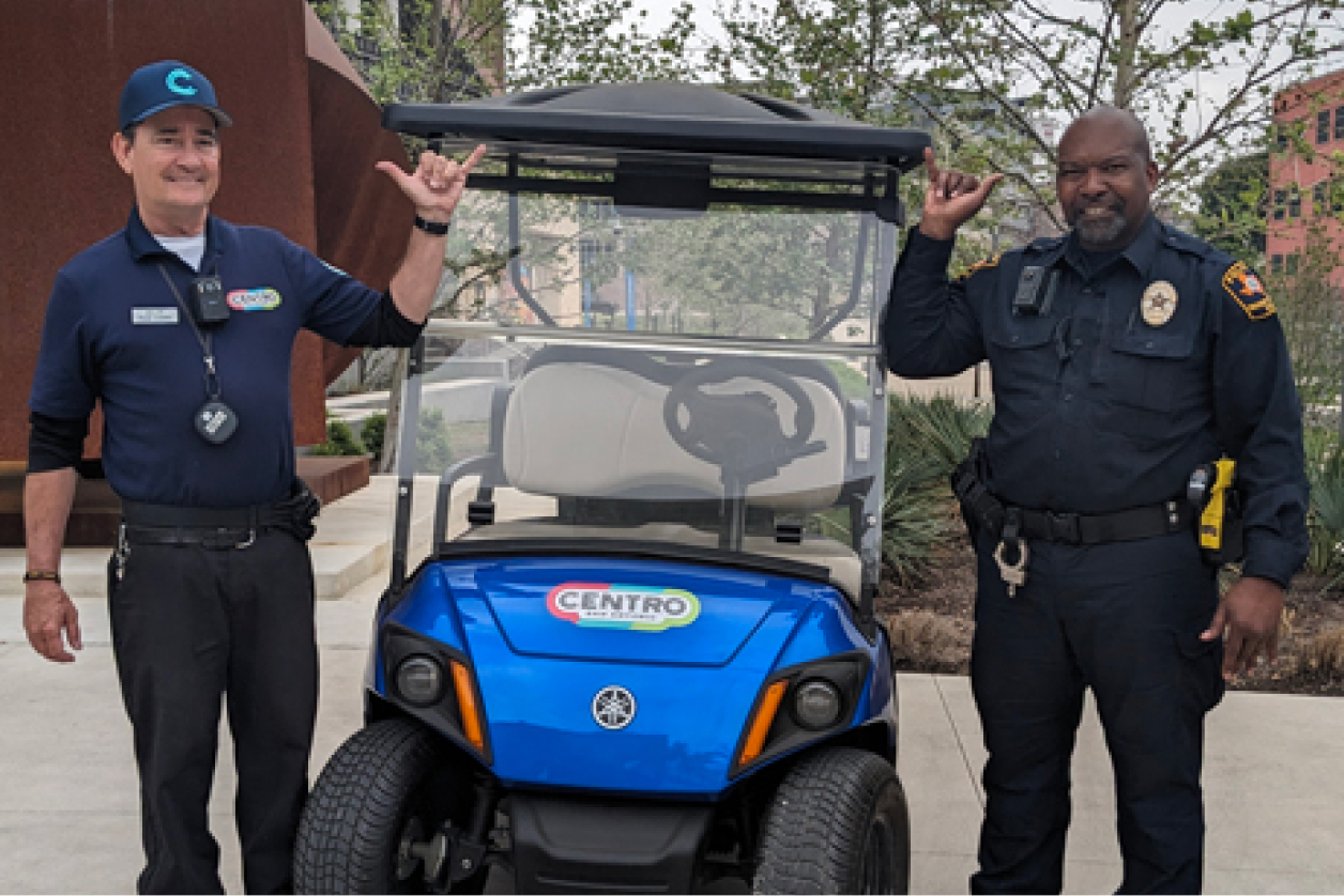 Campus Safety Escorts standing next to a golf cart