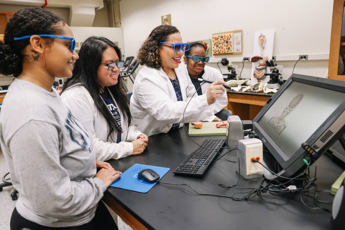Female instructor with her students showing them 3D technology