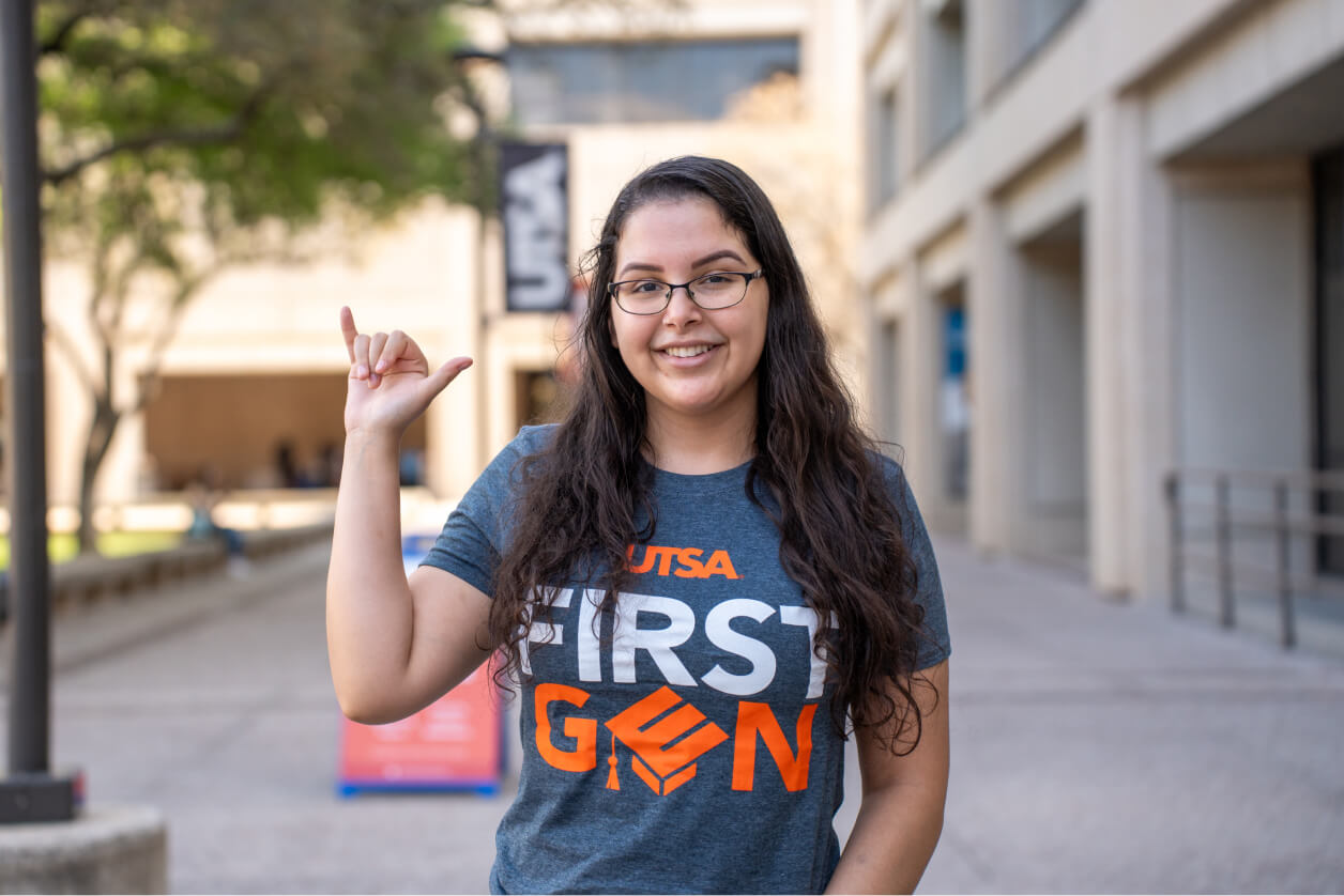 Female student holding her hand up signaling 'Birds Up'