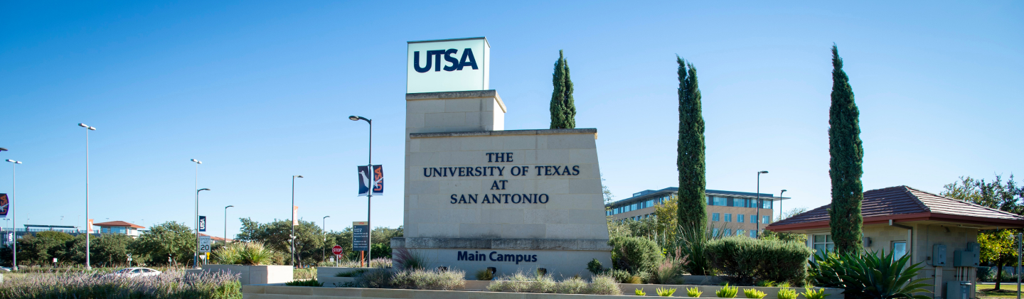 UTSA Monument in the foreground, cars and building in the background
