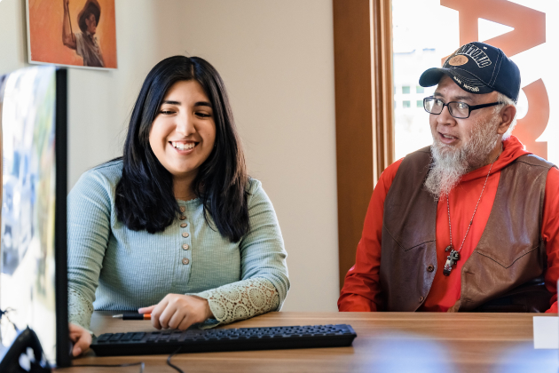 Female student with older male sitting in front of a desk
