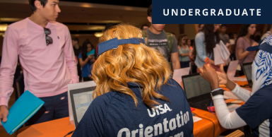 Student at table helping another student with info