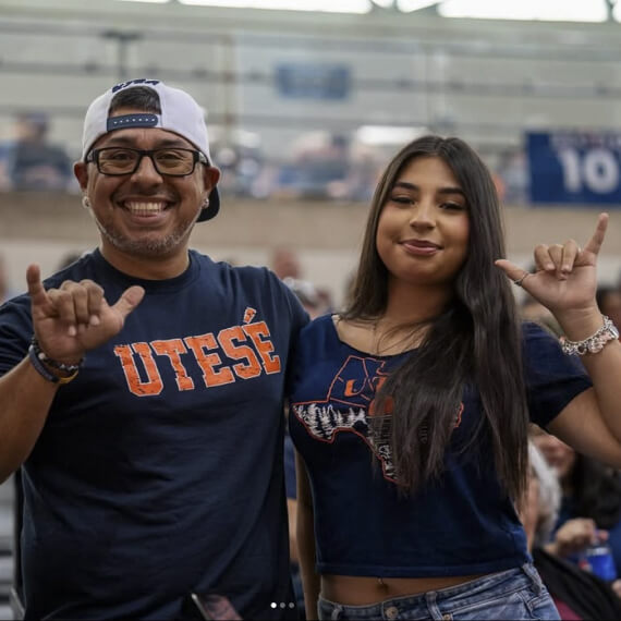 A couple at a UTSA game holding up their 'Birds Up' hand signs