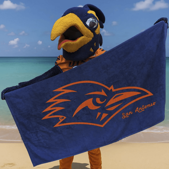 Rowdy Roadrunner holding and extending a Rowdy beach towel at the beach