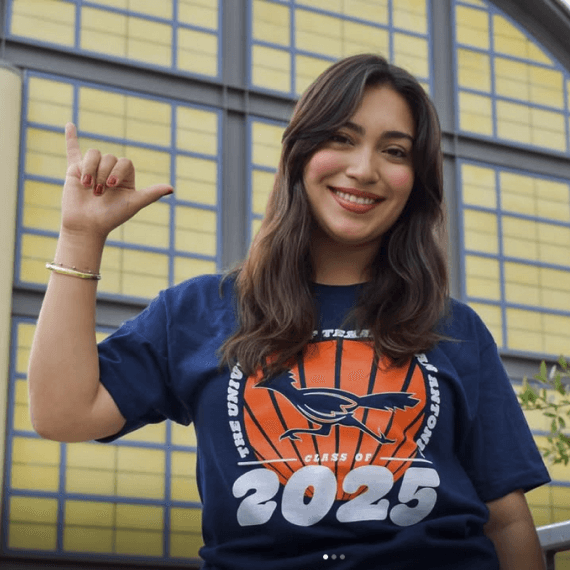 UTSA female student holding a 'Bird's Up' hand signal