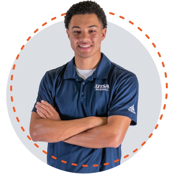 Isaiah Walker smiling big with his arms crossed in front of him wearing a blue UTSA Basketball polo shirt