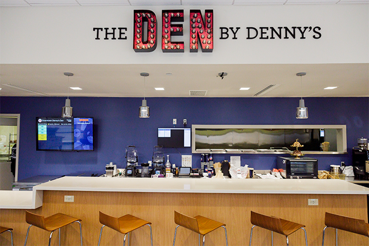 The Den by Denny's signage above a bar area