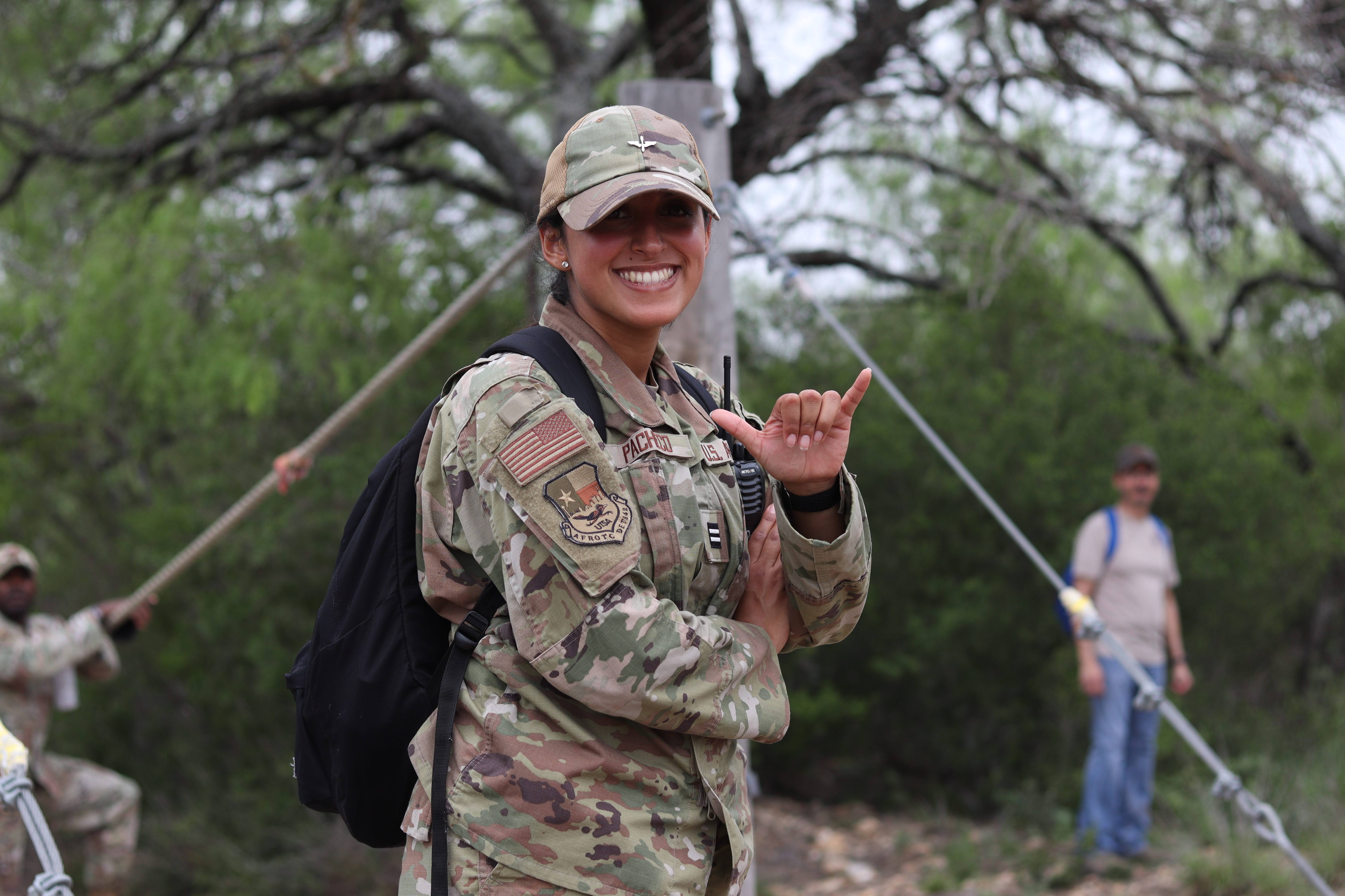 Student in uniform doing the birds up hand sign