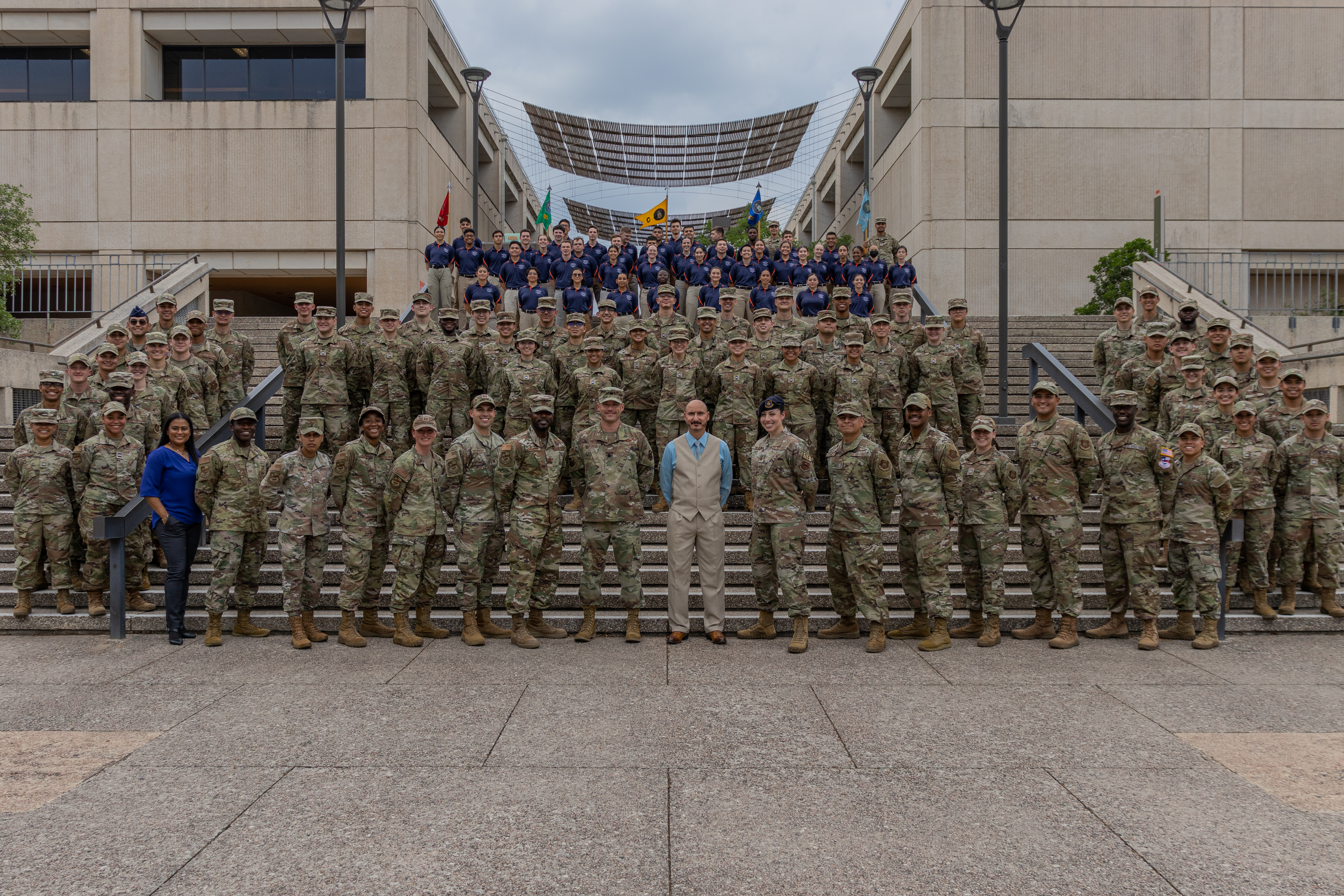 Group photo on campus with everyone in uniforms