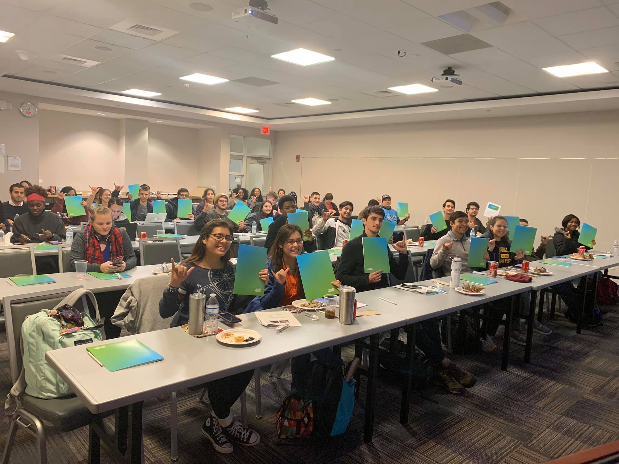 UTSA students and alumni giving birds up in classroom at Credit Human Financial Health Workshops