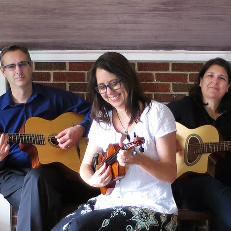 Los Djangoleros posing with guitars