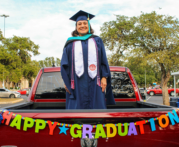Student in back of pickup after graduating