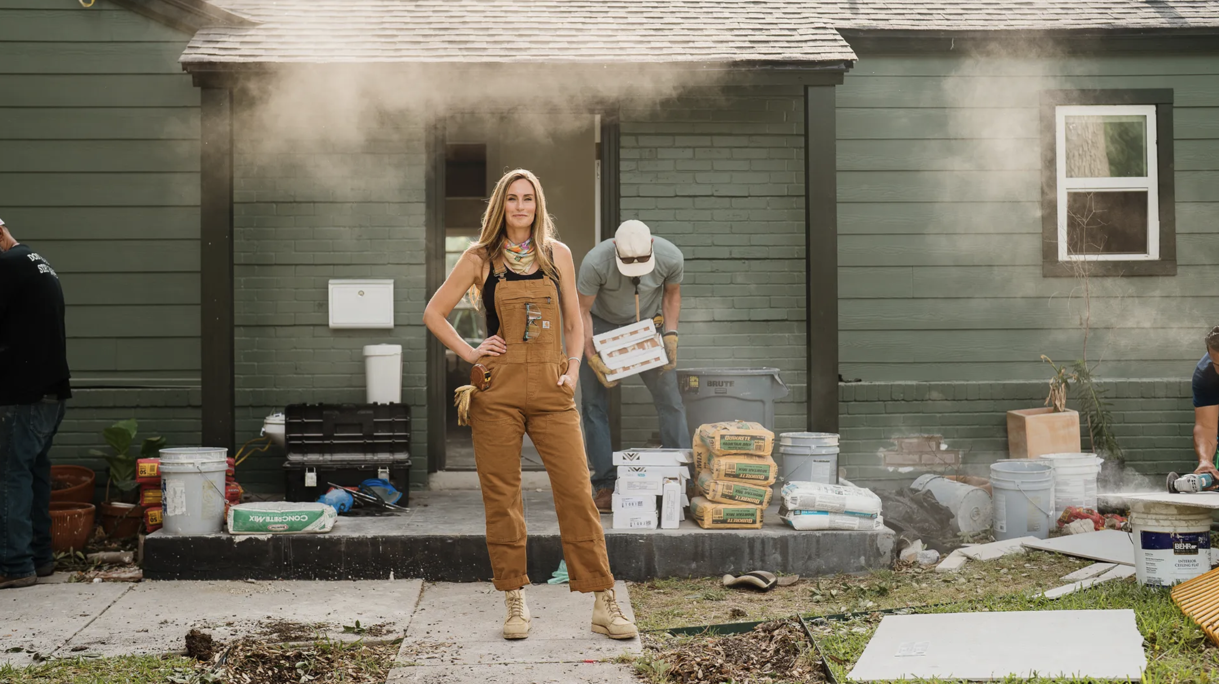 Kim Wolfe standing in front of home under construction