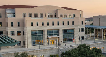 Aerial view of the main building with a sunset behind.