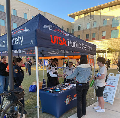 Picture of people on campus in front of a UTSA Public Safety tent 