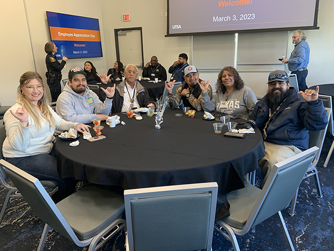 a table of happy UTSA employees