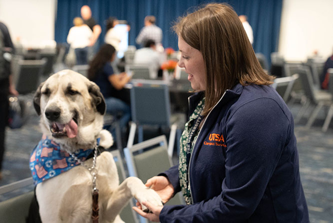 Employee Appreciation 2025 photo 4 - Staff member holding a dog's paw.