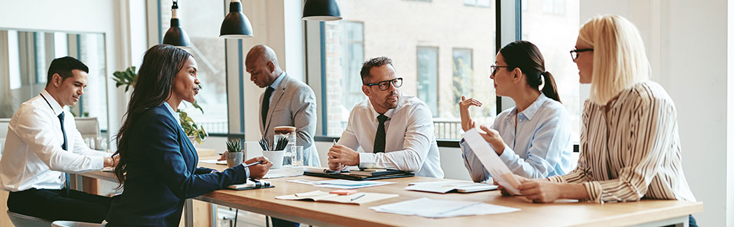 header image of group talking at table