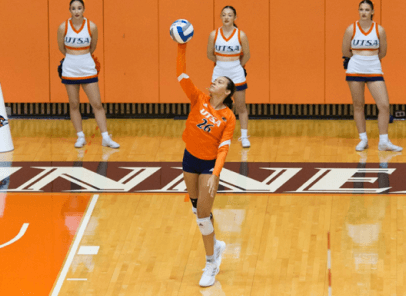 Volleyball player serving the ball in the game.