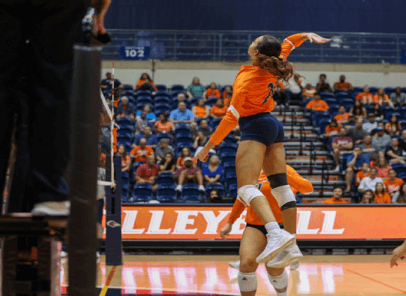 Volleyball player jumping in the air to spike the volleyball.
