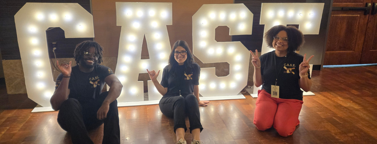Students taking a photo with the check they won