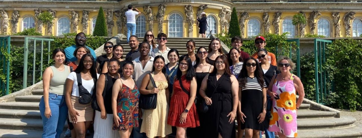 Students taking a photo with the check they won