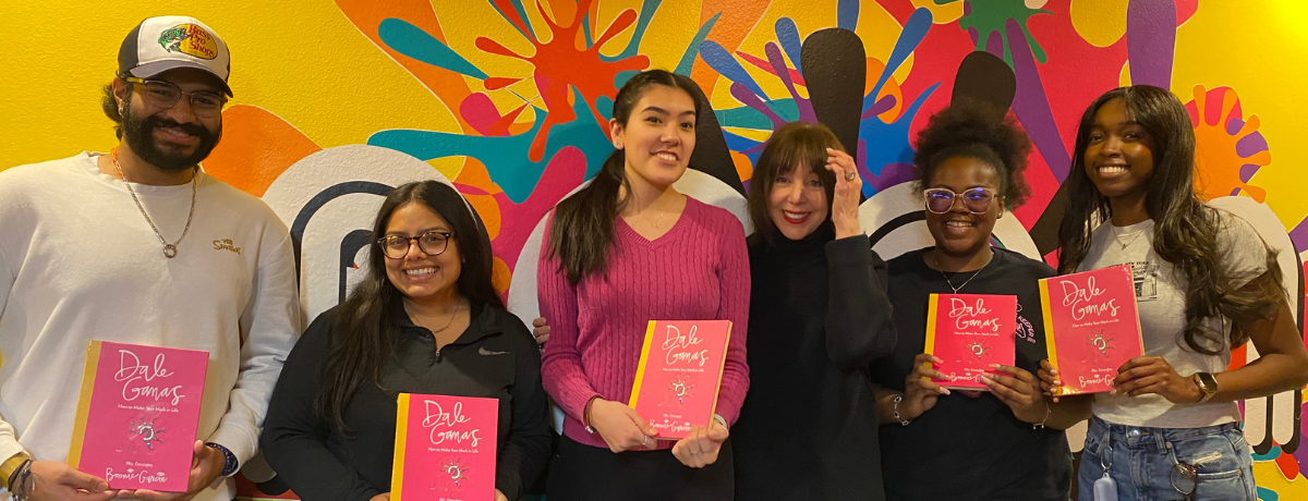 Students taking a photo with the check they won