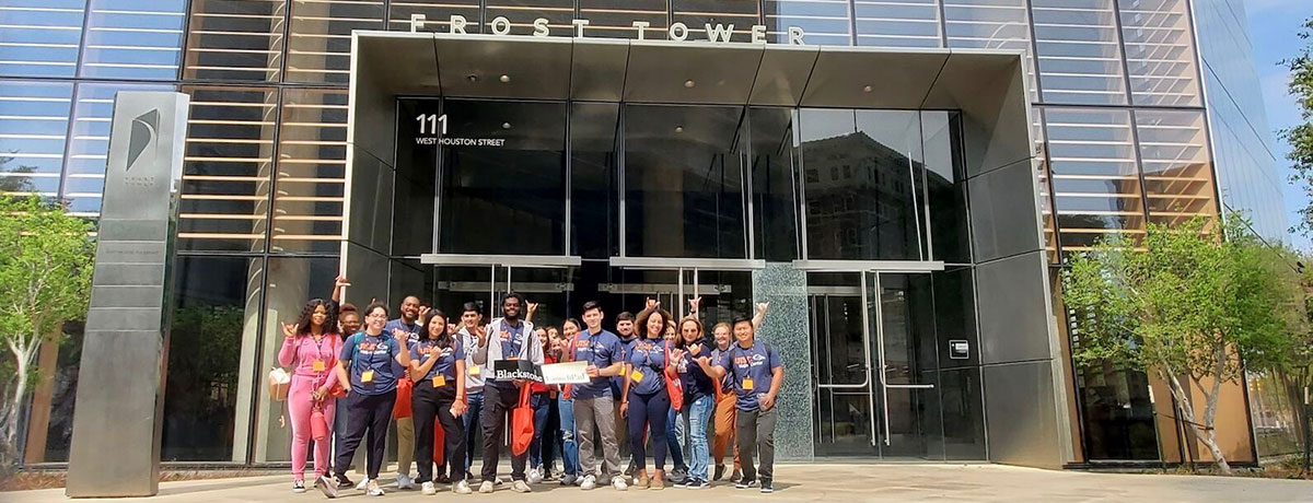 Students taking a photo with the check they won