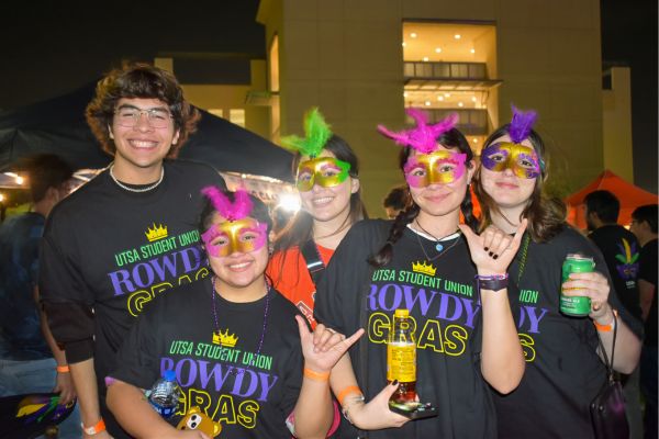 Five students in Rowdy Gras shirts hoding their Birds Up